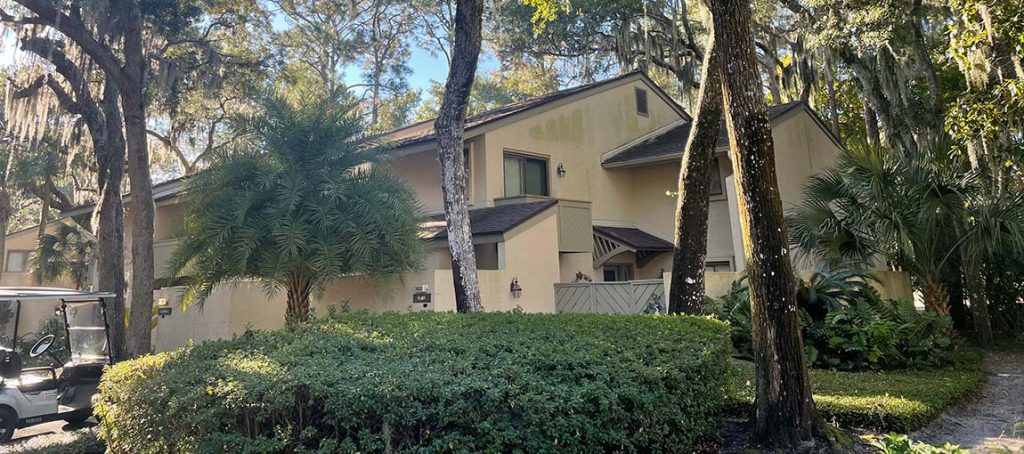 home with mildew stains on stucco